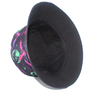 Close-up of reversible bucket hat featuring neon bat and moon patterns on black canvas