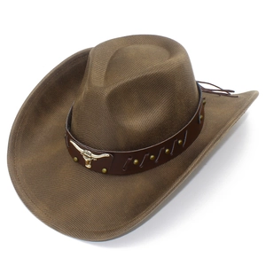 Detailed macro of brown cowboy hat with leather band and gold bull head metal badge