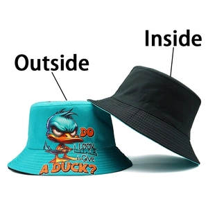 Detail of reversible cotton bucket hat with cute cartoon duck print and black interior side