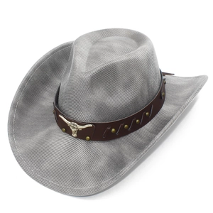 Detail of grey cowboy hat featuring a leather band with rivets and a longhorn bull emblem