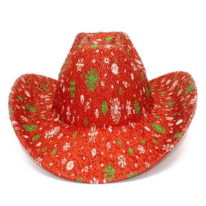 Close-up of red sequined Christmas cowboy hat with festive snowflake and tree patterns