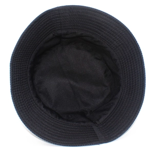 Detail view of black canvas bucket hat showing reinforced brim stitching and inner fabric