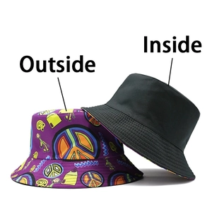 Detail of reversible bucket hat showing colorful peace sign patterns and solid black inside