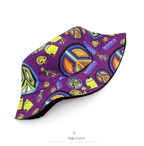 Detail of purple graffiti bucket hat with peace signs and reinforced brim stitching