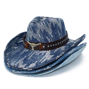 Close-up of blue sequin cowboy hat with brown leather band and metal bull head logo