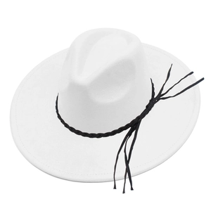 Close-up of a white wide-brimmed fedora hat with a black woven band and long tassel details