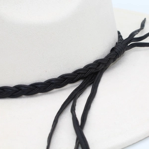 Detail of the black braided leather band knot on the white wide brim felt fedora hat