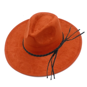 Close-up of bright orange fedora hat featuring black braided leather band with tassels