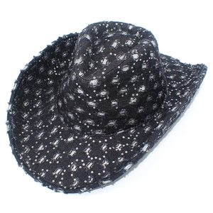 Close-up of black denim cowboy hat with metallic silver sequins and distressed details