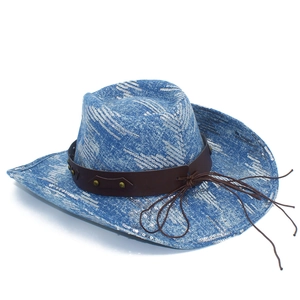 Detailed macro view of blue cowboy hat with white wave textures and brown studded leather band