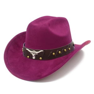 Detail of fuchsia suede cowboy hat featuring a leather band with silver bull skull and brass studs