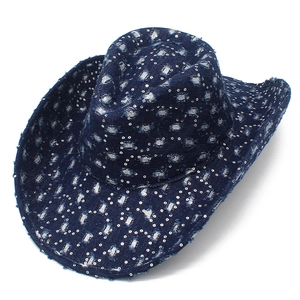 Detailed close-up of blue denim cowboy hat featuring silver sequins and distressed details