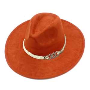 Detail of caramel wide brim fedora with white braided rope and metal chain ornament