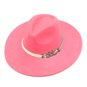 Detailed top view of hot pink wide-brim fedora hat with white braided rope and gold chain link