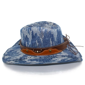 Detail of blue sequined cowboy hat with brown leather band and metallic studs