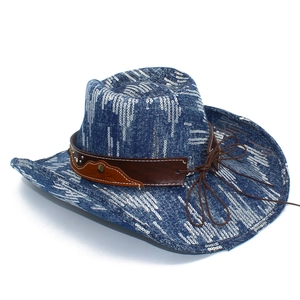 Detail of blue denim cowboy hat featuring white sequin stripes and leather band with studs