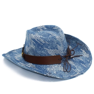 Detail of blue denim cowboy hat featuring silver sequins and brown faux leather strap