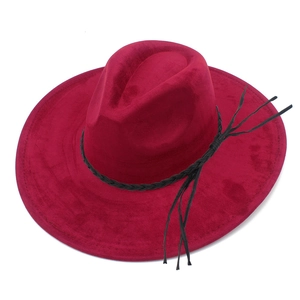Detailed close-up of dark red suede fedora hat with black woven leather band and tassels