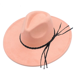 Detail of peach pink wide brim fedora hat with black braided leather rope and fringe tassel