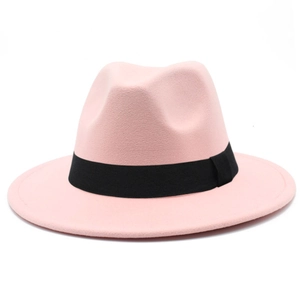 Detail of a pink wool fedora hat featuring a black ribbon band and textured felt finish