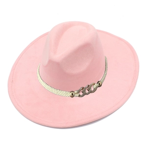 Close-up of pink faux suede fedora with wide brim and white woven band with metal buckle