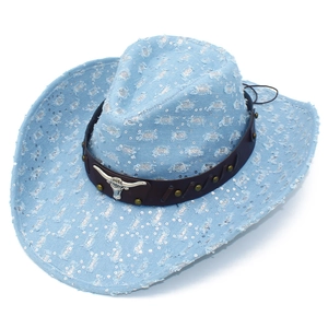 Detail of light blue denim cowboy hat with silver sequins and metallic bull head emblem