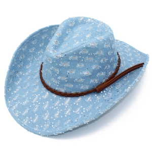 Detail of light blue denim cowboy hat with silver sequins and brown leather band