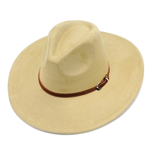 Detail of wide brim beige fedora with brown leather band and golden metal buckle