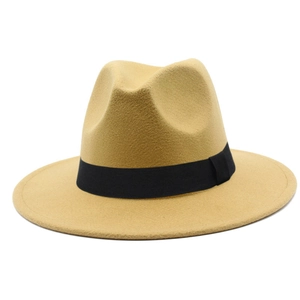Close-up of camel fedora hat with black grosgrain ribbon and wide flat brim texture