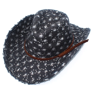 Close-up of denim cowboy hat with silver sequins, woven leather strap and fringe detail
