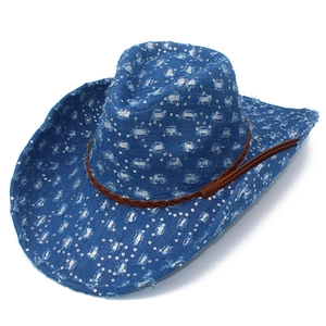 Close-up of blue denim cowboy hat with silver sequins and brown braided leather strap