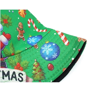 Detailed view of festive green bucket hat with gingerbread man and candy cane prints