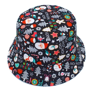 Detail of Christmas bucket hat with Santa, snowman and festive tree patterns on black cotton