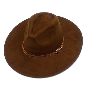 Detail of coffee brown suede fedora with wide brim and leather decorative buckle strap