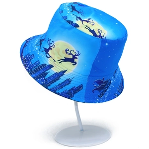 Detail of Christmas bucket hat with reindeer, moon and city skyline pattern over blue gradient