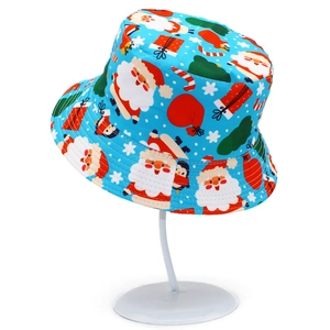 Close-up of Christmas bucket hat with Santa Claus and penguin festive patterns