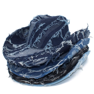 Detail of frayed edge denim cowboy hat with patchwork stitching and distressed texture