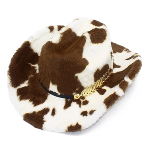 Detail of faux fur cow print cowboy hat featuring a golden leaf ornament and black band
