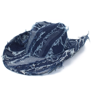 Distressed blue denim cowboy hat with frayed edges and vintage aesthetic for outdoors