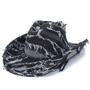 Distressed black denim cowboy hat with raw frayed edges and vintage wide brim style