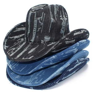 Detail showing stacked distressed denim cowboy hats in black, dark blue, and light blue