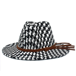Classic houndstooth jazz hat with black and white pattern and brown leather tassel band