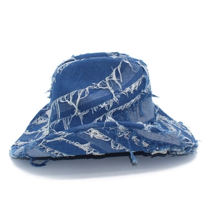 Detailed view of frayed edges and distressed texture on dark blue denim jazz hat