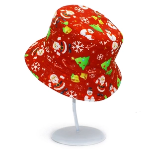Close-up of red Christmas bucket hat with Santa Claus, snowmen and reindeer prints