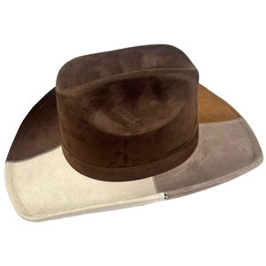 Macro detail of western cowboy hat with multi-color suede patchwork and decorative stitching