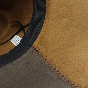 Detailed close-up of fedora hat interior showing Z-stitch seam and polyester label