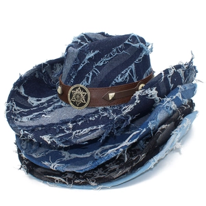Detail of distressed denim cowboy hats with vintage fringe edges and metal sunburst emblems