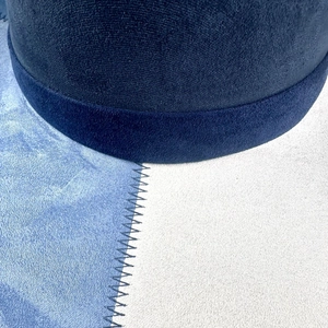 Detail of classic cowboy hat showing denim and suede patchwork with zigzag stitching