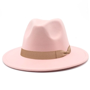 Close-up of pink felt fedora hat featuring a classic brown ribbon band and side bow detail