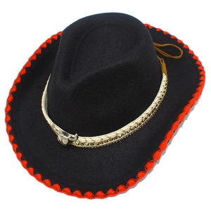 Detail of western cowboy hat featuring red stitched brim and metallic bull head ornament